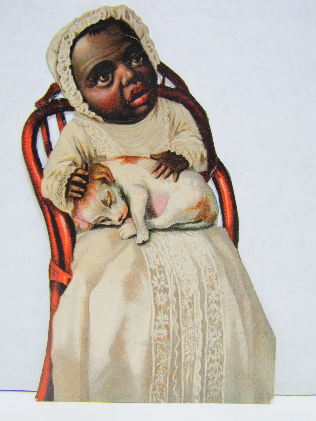 CREEPY LOOKING ANTIQUE BLACK AMERICANA CHILD IN DRESS WITH DOG IN CHAIR PAPER CUT-OUT