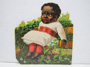 CREEPY ANTIQUE BLACK AMERICANA CHILD IN DRESS SITTING IN GARDEN PAPER CUT-OUT